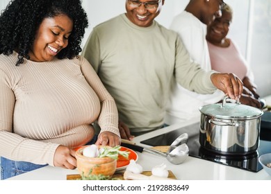 Happy Black Family Cooking Inside Kitchen At Home - Focus On Girl Face