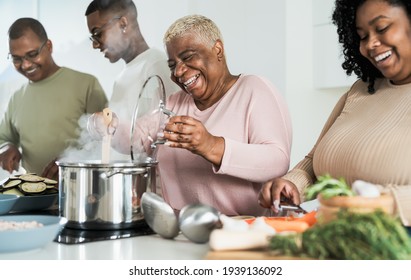 Happy Black Family Having Fun Cooking Together In Modern Kitchen - Food And Parents Unity Concept 