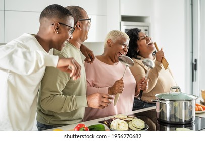 Happy Black Family Having Fun Cooking Together In Modern Kitchen - Food And Parents Unity Concept 