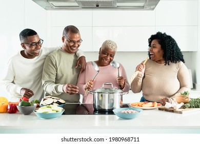 Happy Black Family Having Fun Cooking Together In Modern Kitchen - Food And Parents Unity Concept 