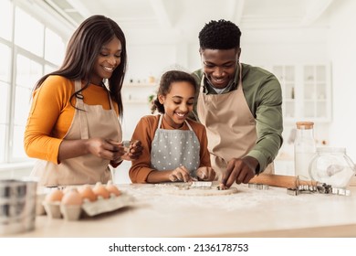 Happy Black Family Making Cookies Using Baking Forms Having Fun And Cooking Together Standing In Modern Kitchen At Home On Weekend. Pastry Recipes, Food And Nutrition Concept - Powered by Shutterstock