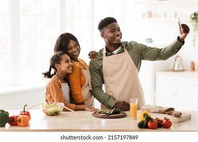 Happy Black Family Making Selfie On Phone While Cooking Having Fun Preparing Dinner Together In Modern Kitchen Indoor On Weekend. Healthy Recipes, Nutrition Concept - Powered by Shutterstock