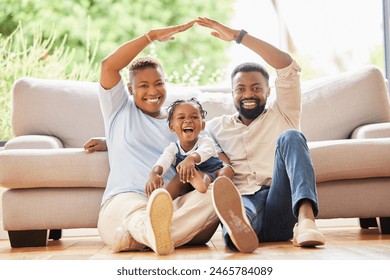 Happy black family, portrait and roof with protection for mortgage, investment or moving in new home. African mother, father and child with smile for shelter, property or house loan in living room - Powered by Shutterstock