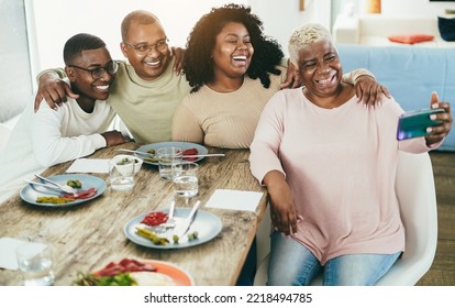 Happy Black Family Taking A Selfie With Mobile Phone At Home - Focus On Girl Face