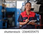 Happy Black female supervisor mechanic, cheerful smile, inspects repair work checklists with tablet at garage, service car maintenance, and fixing specialist occupations in auto transport industry.