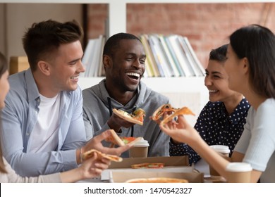 Happy Black Guy Chilling Together With Indian, Asian And Caucasian Friends, Laughing, Eating Pizza, Joking, Having Fun. Group Of Diverse Smiling Students Ordered Takeaway Delivery Fast Food At Campus.