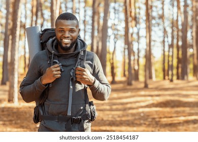 Happy black guy hiking with caucasian friends by countryside, forest background - Powered by Shutterstock