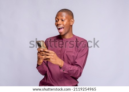 Similar – African man blue background with mobile phone.