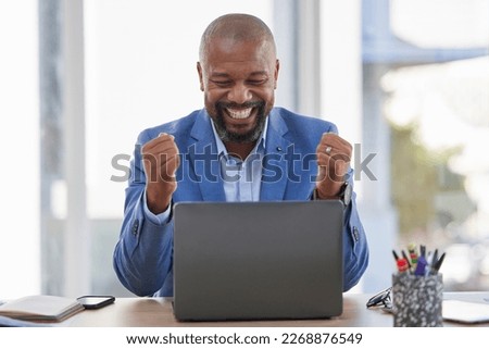 Happy black man, laptop and celebration for winning, sale or good news on discount at the office desk. Excited African American male celebrating on computer for promotion, bonus or achievement