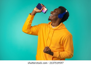 Happy Black Man Listening To Music On Phone With Headphones In Studio