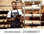 Happy black man, tablet and portrait in bakery or small business to check stock or order. Technology, smile and face of professional baker in factory for manufacturing or food production in Nigeria