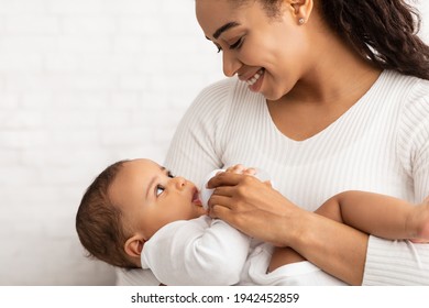 Happy Black Mother Feeding Newborn Baby Giving Bottle, White Background