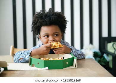 Happy black people African American child eat pizza on table