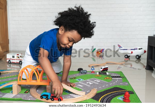 Happy black people African American child play toy at\
home 