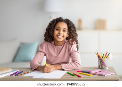 Happy Black Schoolgirl Drawing Picture At Home