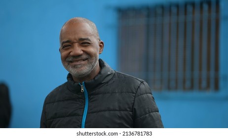 A Happy Black Senior Man Standing Outside In Street Smiling At Camera