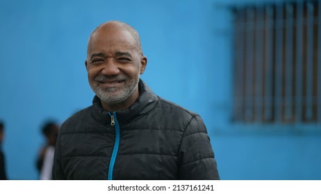 A Happy Black Senior Man Standing Outside In Street Smiling At Camera