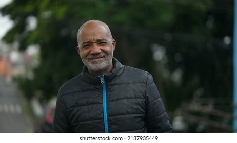 A Happy Black Senior Man Standing Outside In Street Smiling At Camera