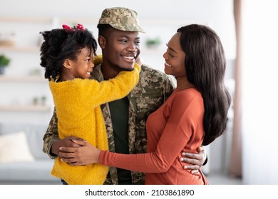 Happy Black Wife And Daughter Welcoming Military Father At Home After Army, Excited Cheerful African American Soldier Man Celebrating Reunion With Family, Embracing And Smiling Together, Free Space - Powered by Shutterstock