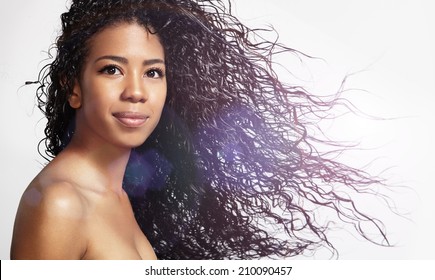 Happy Black Woman With Blowing Curly Hair 