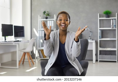 Happy Black Woman Clapping Hands Sitting On Modern Office Chair. Webcam Portrait Smiling Overjoyed Business Lady In Suit Applauding Congratulating You On Successful Presentation, Conference Or Webinar