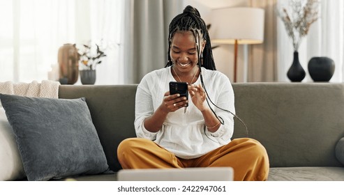 Happy, black woman and credit card with phone on sofa for online shopping, payment code and fintech at home. Mobile banking, finance and password to upgrade subscription, ecommerce and money savings
