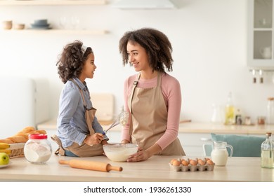 Happy Black Woman And Daughter Kneading Dough In Kitchen