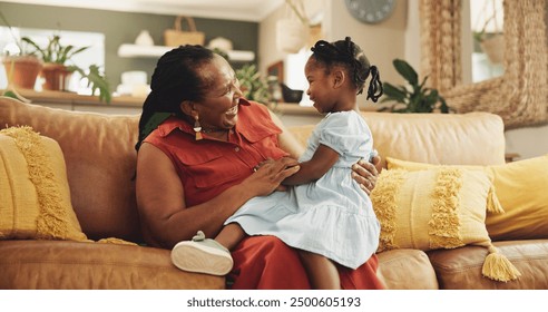 Happy, black woman and fun with child at house for bonding, love and care together of family support on sofa. Smile, grandmother and girl relax on sofa for playful, trust and connection in lounge - Powered by Shutterstock