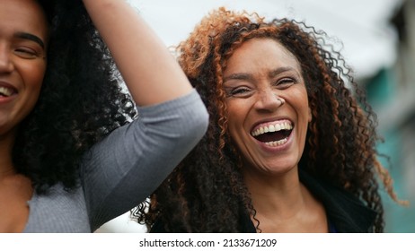 A happy black woman laughing and smiling a casual hispanic 40s lady real life laugh and smile
