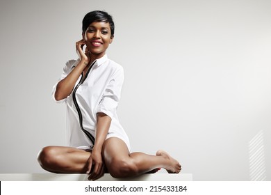 Happy Black Woman In Man Shirt In Neutral Room