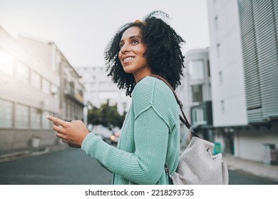 Happy, black woman and phone for travel in the city of a tourist enjoying sightseeing in an urban street. African American female traveler in communication or navigation on smartphone in South Africa - Powered by Shutterstock