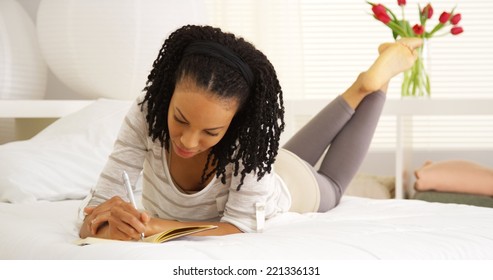 Happy Black Woman Writing In Journal