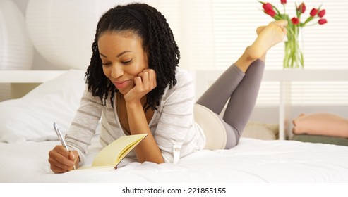 Happy Black Woman Writing In Journal