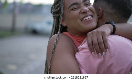 A Happy Black Young Woman Embracing Family Member. Brazilian Sister Embraces Brother. South American People Love And Affection. Person Hugging