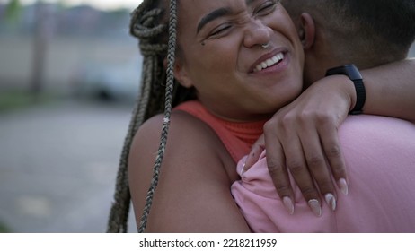 A Happy Black Young Woman Embracing Family Member. Brazilian Sister Embraces Brother. South American People Love And Affection. Person Hugging