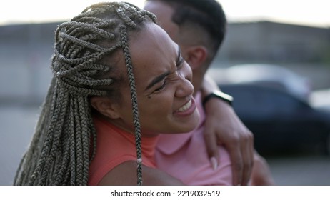 A Happy Black Young Woman Embracing Family Member. Brazilian Sister Embraces Brother. South American People Love And Affection. Person Hugging