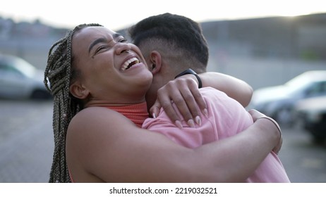 A Happy Black Young Woman Embracing Family Member. Brazilian Sister Embraces Brother. South American People Love And Affection. Person Hugging