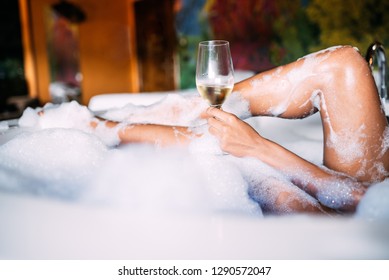 Happy Black Young Woman Relaxing In The Hydro Massage Bath Covered In Foam