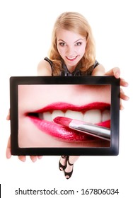 Happy Blond Girl Showing Ipad With Photo Of Female Lips And Red Pink Lipstick. Modern Young Woman Holding Tablet Touchpad Recommending Makeup. Technology And Beauty. Isolated