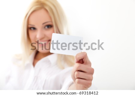 Happy blond woman showing blank credit card. Focus on card.