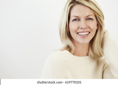 Happy blond woman smiling to camera