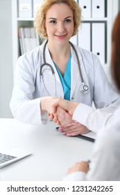 Happy blonde female doctor and patient discussing medical examination results. Medicine, healthcare and help concept - Shutterstock ID 1231242265