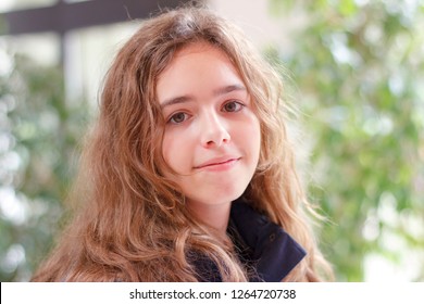 Happy Blonde Teen Girl Smiling And Looking To Camera