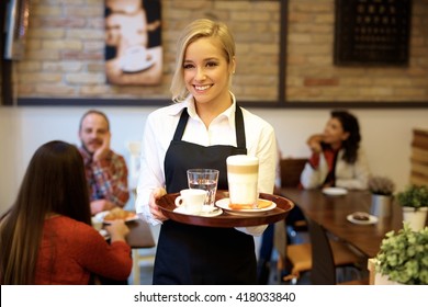 Happy blonde waitress holding tray, smiling. - Shutterstock ID 418033840