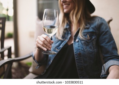 happy blonde woman enjoying white wine and smiling - Powered by Shutterstock