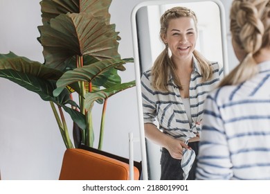 Happy blonde woman looking in the mirror at bedroom. Beautiful plus size woman and her reflection in the mirror - Powered by Shutterstock