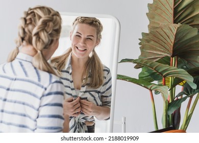 Happy Blonde Woman Looking In The Mirror At Bedroom. Beautiful Plus Size Woman And Her Reflection In The Mirror