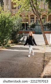 Happy Blonde Woman In Trendy Outfit Walking On Street In Turkey