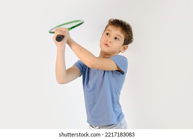 Happy Boy In Badminton Rackets Action On White Background. Children's Badminton Improves Agility And Quick Reflexes, As Well As Coordination, Balance And Concentration