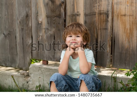 Similar – Cute little boy seated on the wall of a castle